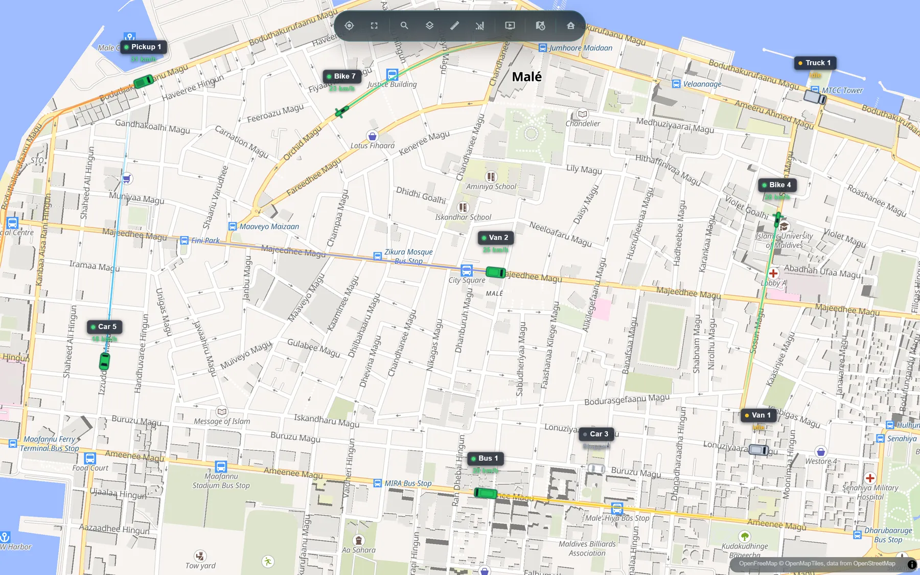 The Dhuveli live map for a vehicle company: Malé's streets with vans, a pickup, a bus, cars and motorcycles, each labelled with its speed in km/h